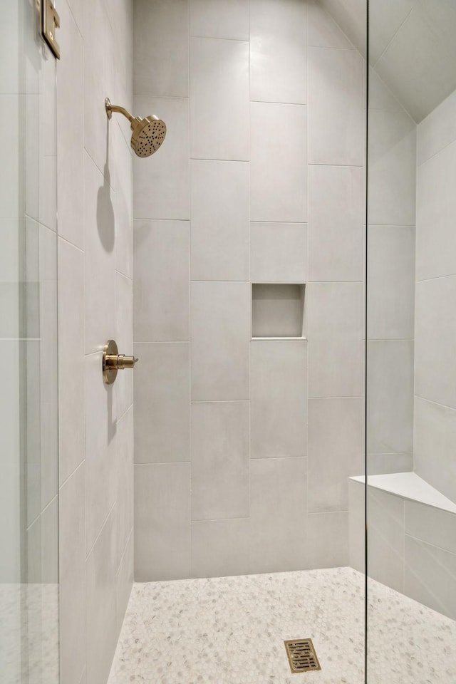 bathroom with a tile shower