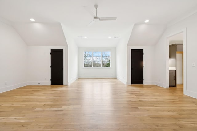 unfurnished room with vaulted ceiling, ceiling fan, and light hardwood / wood-style floors