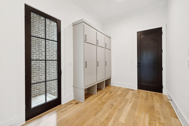 mudroom featuring light wood-type flooring and ornamental molding