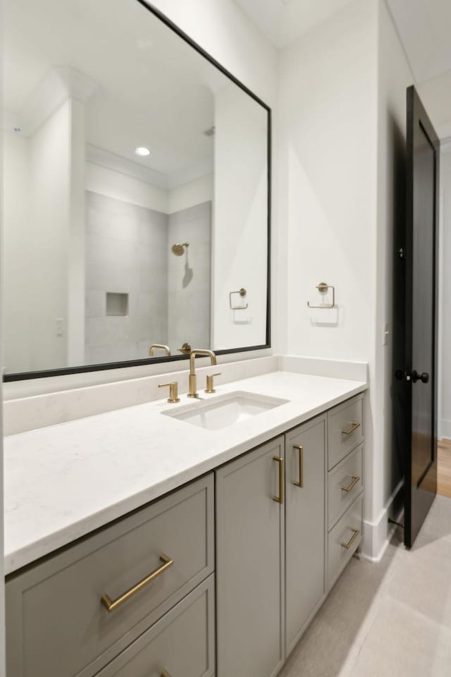 bathroom featuring a shower, vanity, and tile patterned flooring