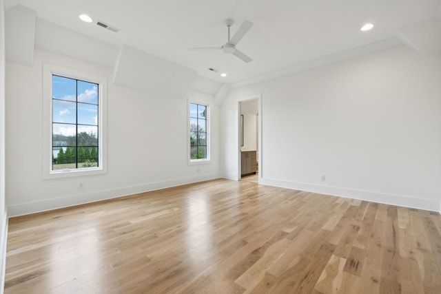 empty room with ceiling fan and light hardwood / wood-style floors