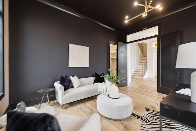 living room with an inviting chandelier and hardwood / wood-style flooring