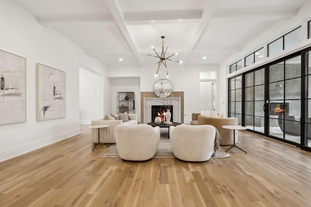 living room featuring a high end fireplace, light hardwood / wood-style flooring, and beamed ceiling