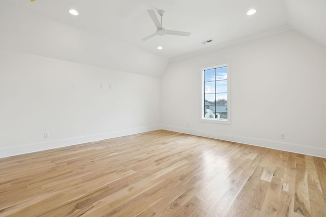 additional living space with lofted ceiling, light wood-type flooring, and ceiling fan