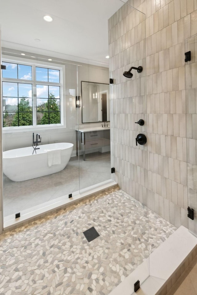 bathroom with tile walls, tile patterned flooring, and shower with separate bathtub