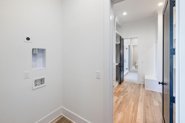 washroom featuring washer hookup, light hardwood / wood-style flooring, hookup for an electric dryer, and ornamental molding