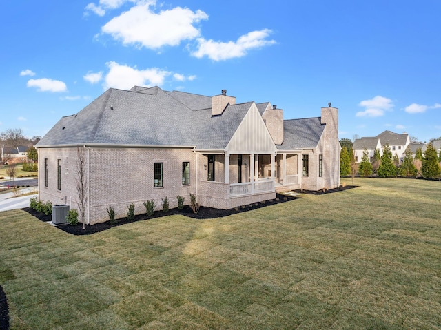 back of property featuring a yard, central AC, and a sunroom