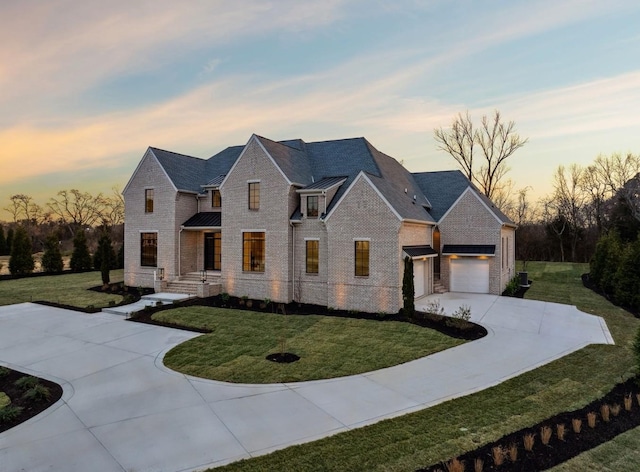 view of front of property featuring a garage and a yard