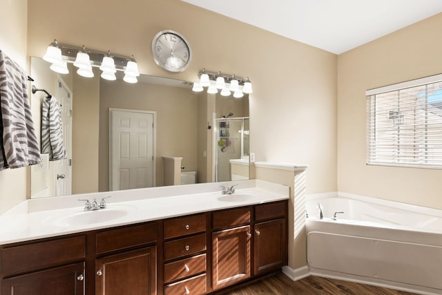 full bathroom with wood-type flooring, vanity, toilet, and independent shower and bath