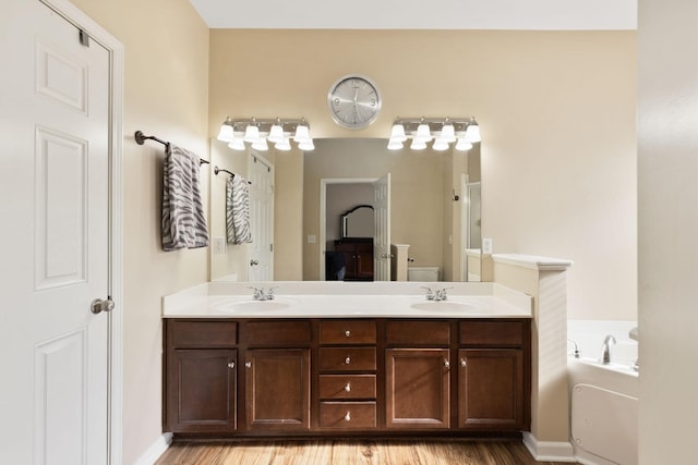 full bathroom featuring vanity, toilet, wood-type flooring, and shower with separate bathtub