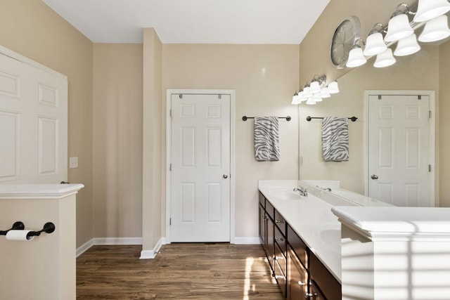 bathroom with hardwood / wood-style flooring, vanity, and a notable chandelier