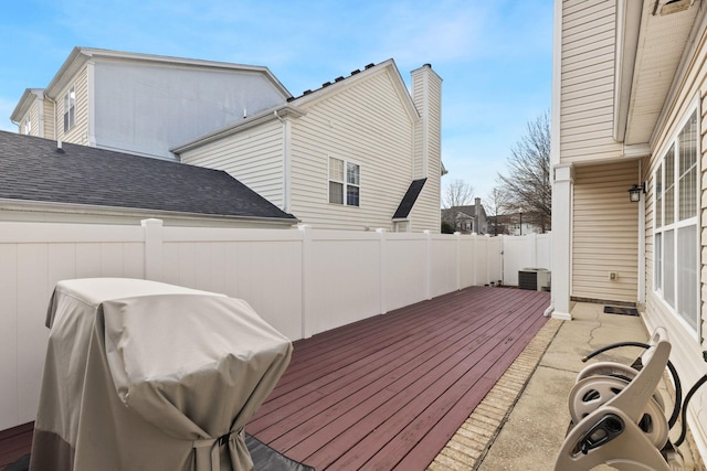 deck featuring central AC unit and area for grilling