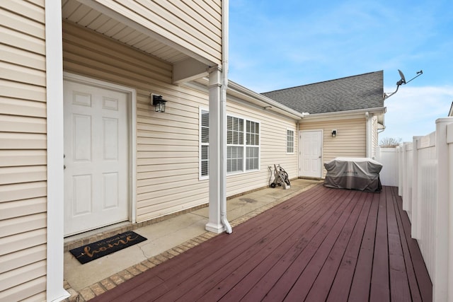 wooden deck with a grill