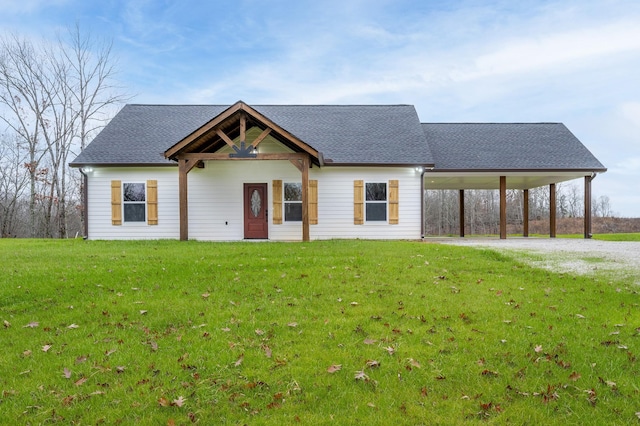 view of front of property with a carport and a front lawn