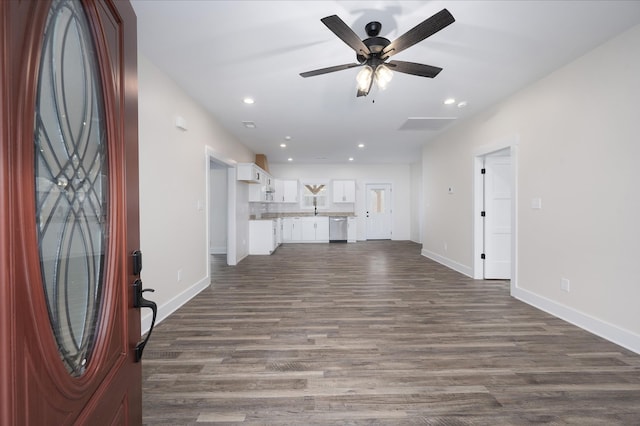 unfurnished living room with ceiling fan and dark hardwood / wood-style flooring