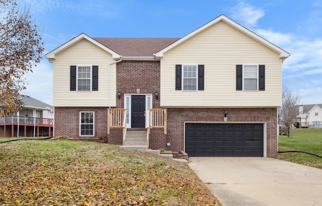 bi-level home with a garage and a front yard