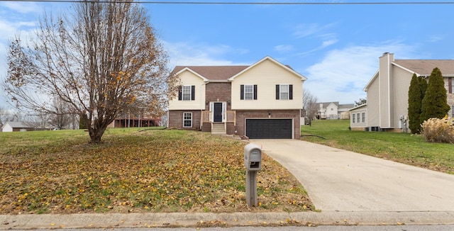 bi-level home with a front yard and a garage