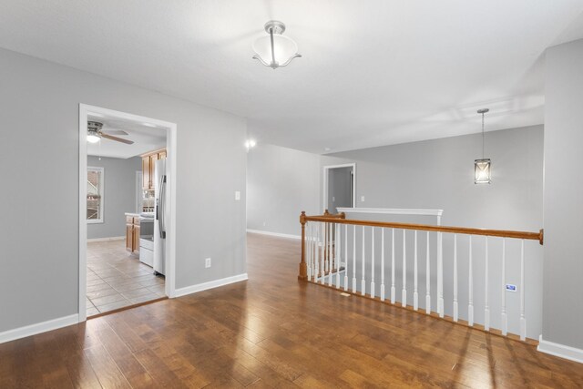 spare room featuring ceiling fan and light hardwood / wood-style floors