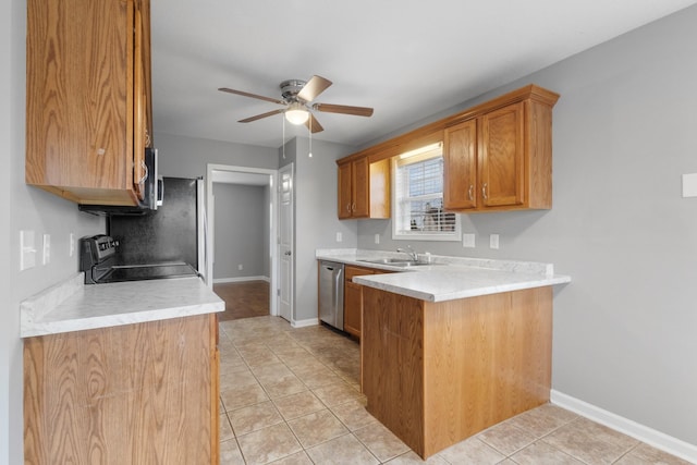 kitchen featuring kitchen peninsula, stainless steel appliances, ceiling fan, sink, and light tile patterned floors