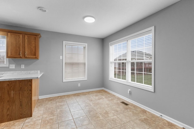 kitchen with light tile patterned flooring