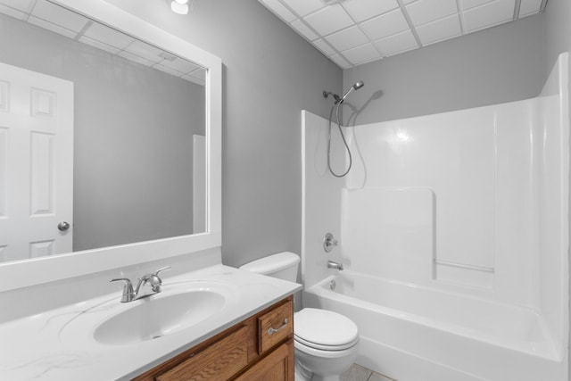 full bathroom featuring tile patterned floors, shower / bath combination, toilet, a paneled ceiling, and vanity