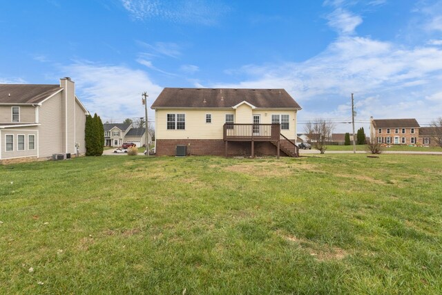 back of property featuring central AC, a yard, and a deck