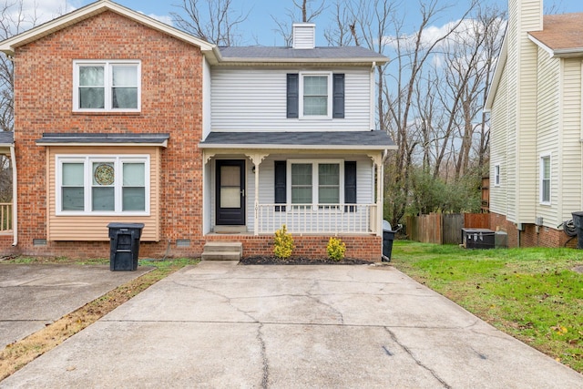 front of property featuring a front yard and covered porch