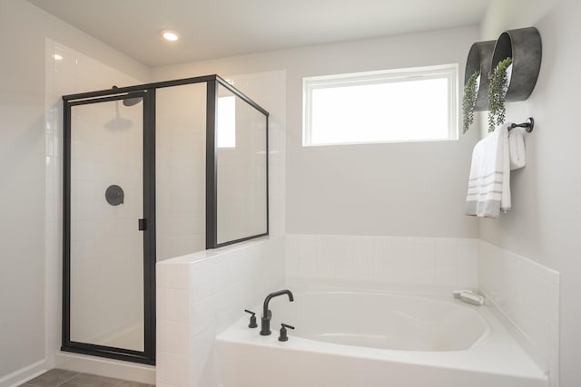 bathroom featuring plus walk in shower