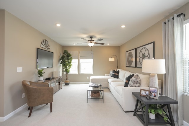 living room featuring light colored carpet and ceiling fan