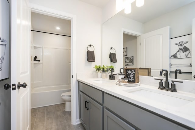 full bathroom featuring vanity, tub / shower combination, and toilet