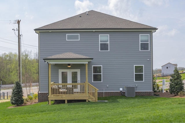 rear view of house featuring a lawn, ceiling fan, a deck, and central air condition unit