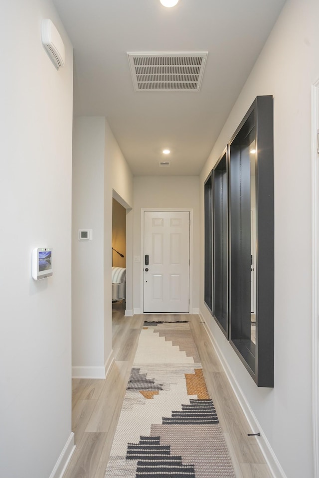 corridor with light wood-type flooring