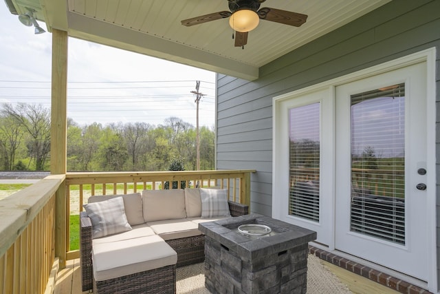 wooden terrace with outdoor lounge area and ceiling fan