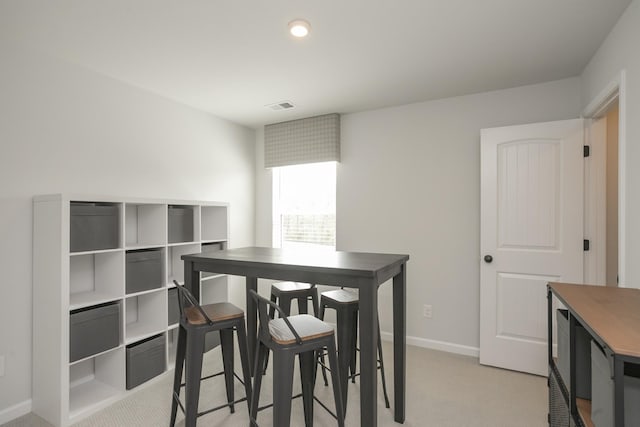 dining space with light carpet