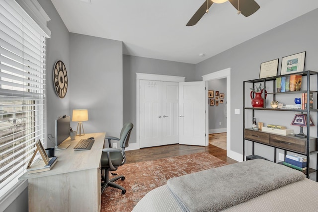 bedroom with a closet, ceiling fan, and dark wood-type flooring