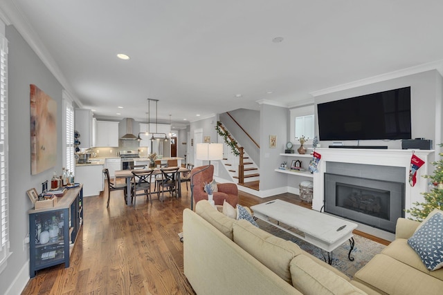 living room with hardwood / wood-style flooring and crown molding