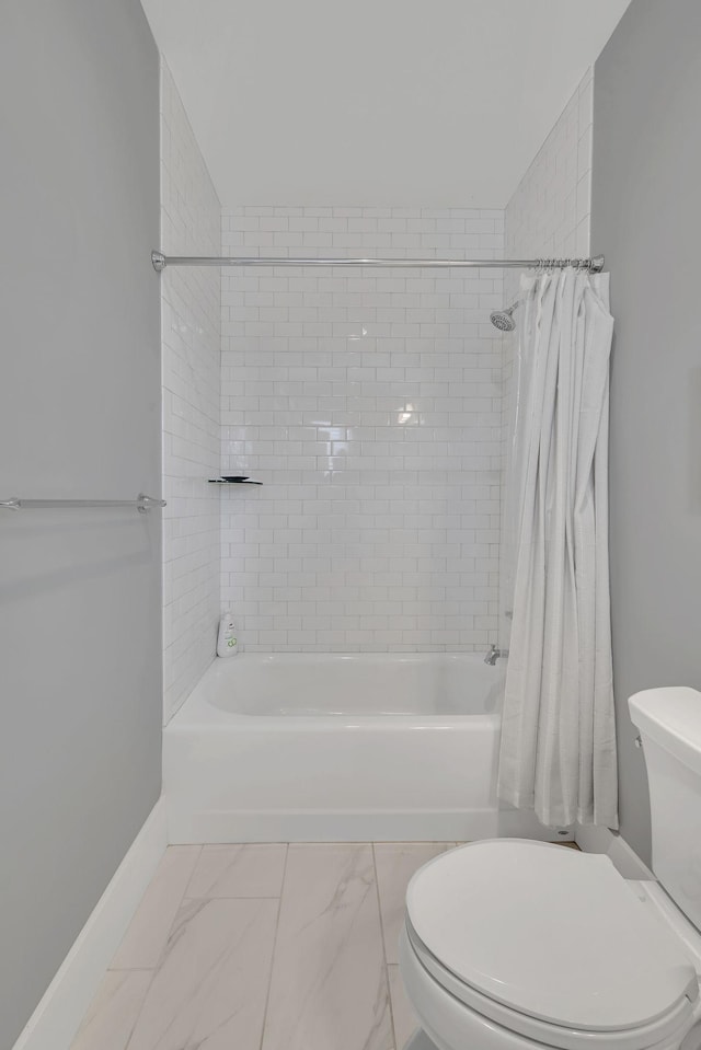 bathroom with shower / bath combination with curtain and toilet