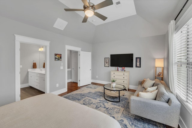 bedroom featuring ensuite bath, ceiling fan, dark hardwood / wood-style floors, and vaulted ceiling