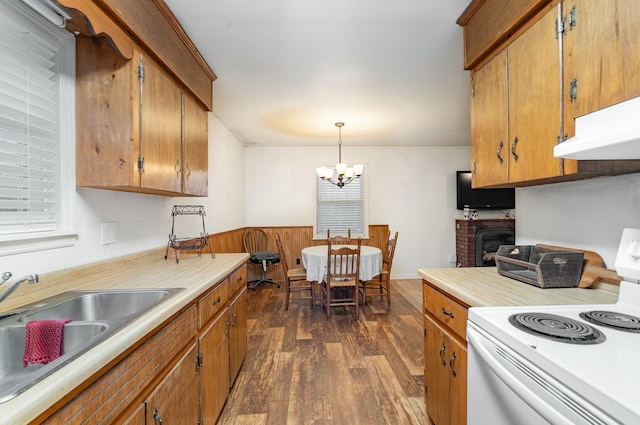 kitchen with sink, decorative light fixtures, a notable chandelier, white electric range, and dark hardwood / wood-style floors