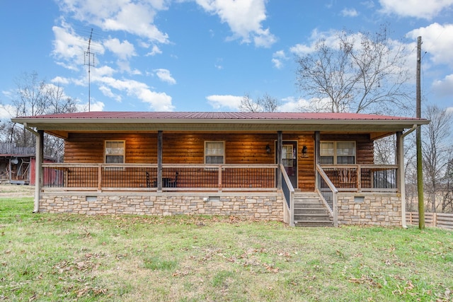 log home featuring covered porch and a front lawn