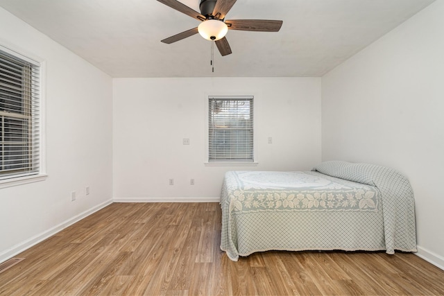 bedroom with ceiling fan and light hardwood / wood-style floors