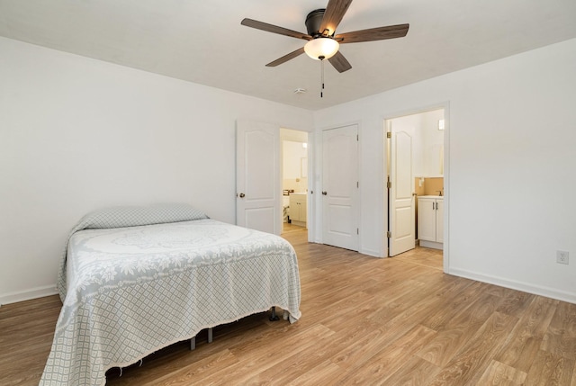 bedroom with light hardwood / wood-style floors, ensuite bath, and ceiling fan