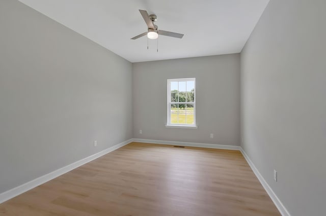 empty room with light hardwood / wood-style floors and ceiling fan