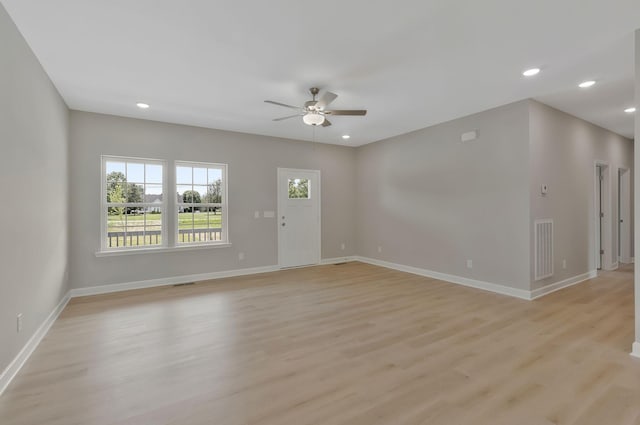 unfurnished living room with ceiling fan and light wood-type flooring