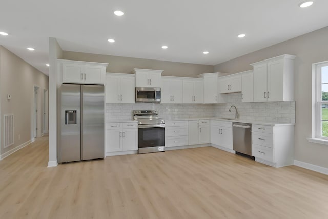 kitchen with sink, white cabinets, and stainless steel appliances