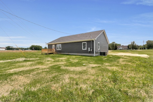 exterior space featuring a deck, central AC, and a yard