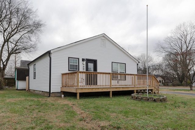 back of house featuring a yard and a wooden deck