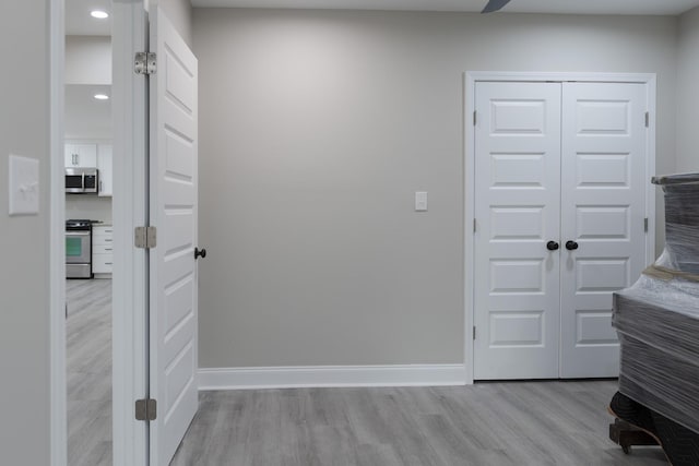 hallway with light hardwood / wood-style flooring