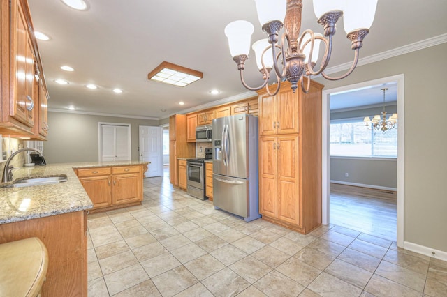 kitchen with a chandelier, stainless steel appliances, crown molding, and sink