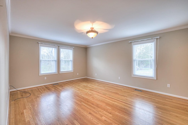 unfurnished room featuring crown molding and light hardwood / wood-style flooring